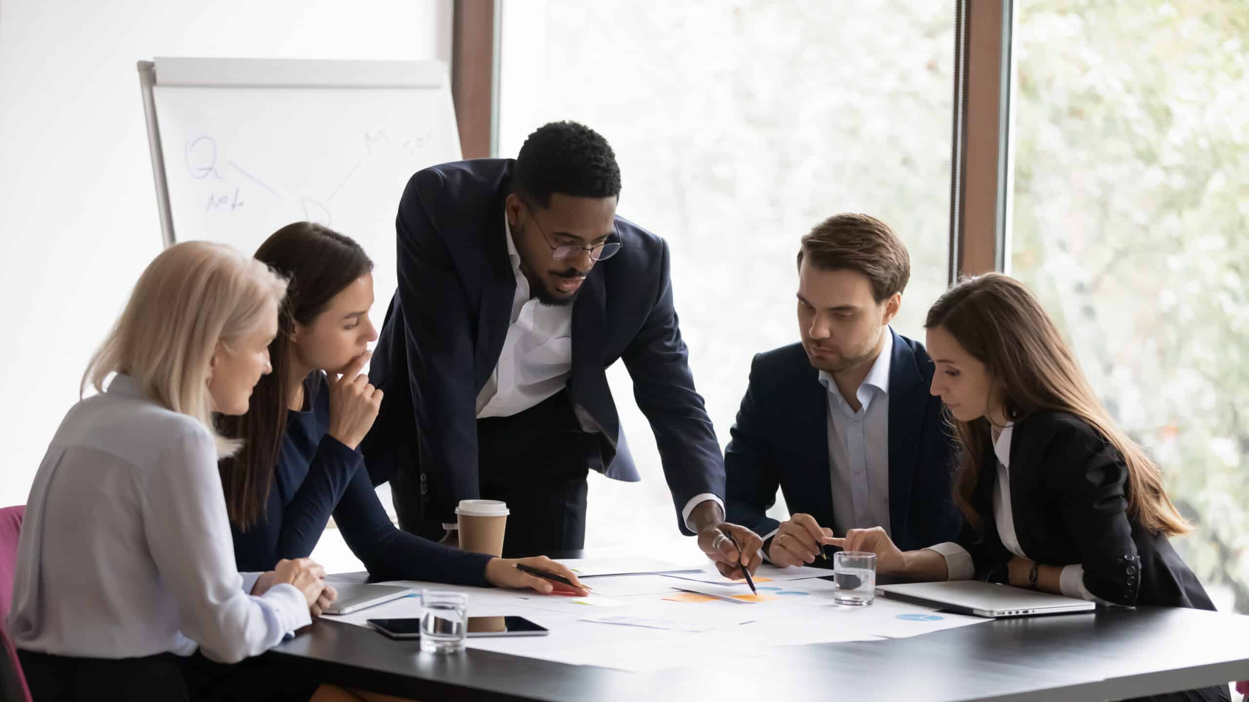 A CFO leading his team and explaining financials.