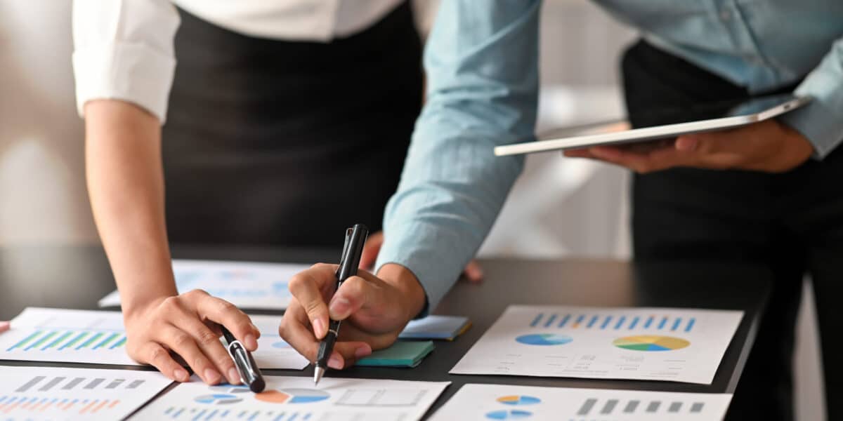 Two people going over financial statements together.