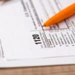 IRS form 1120 with a pencil