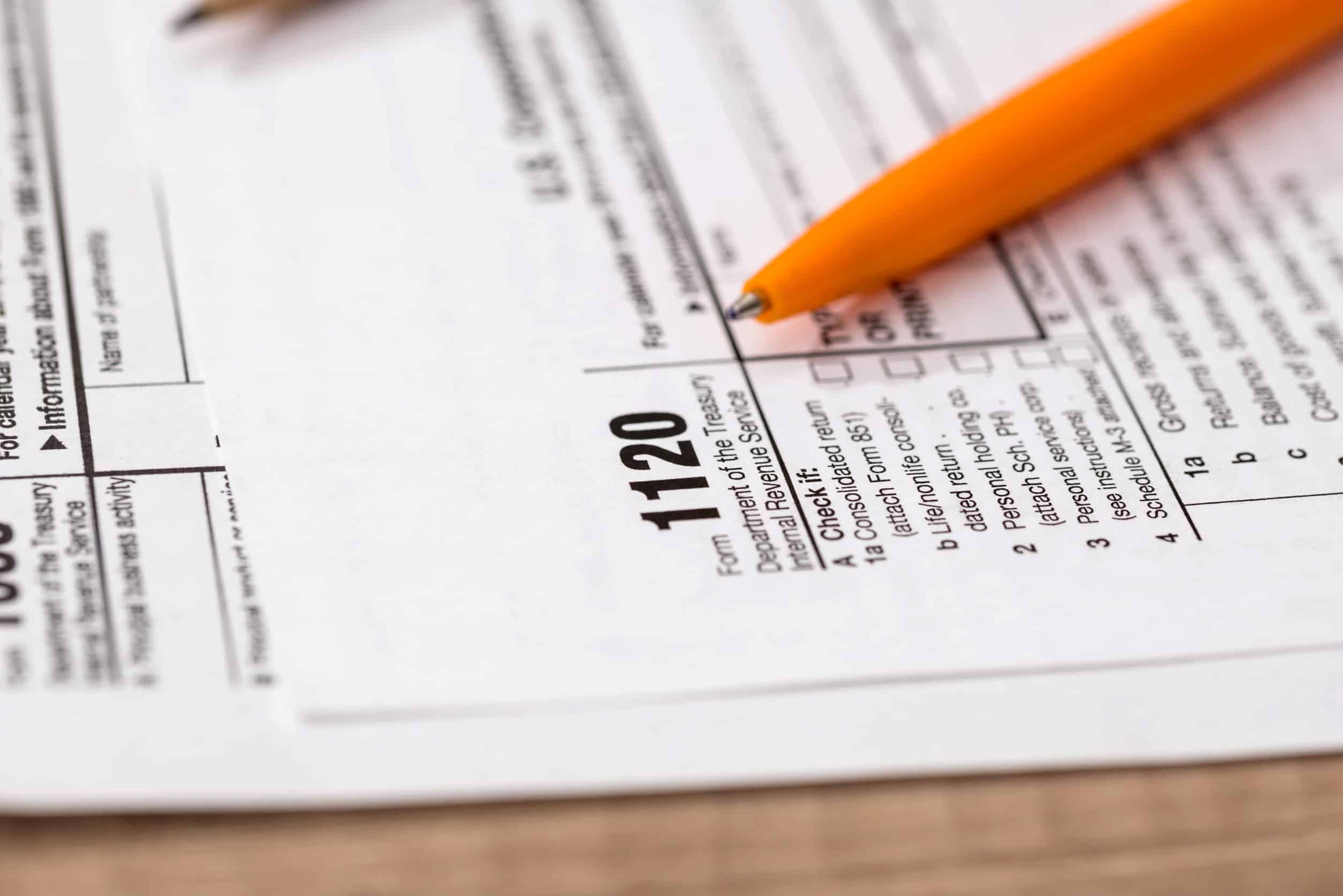 IRS form 1120 with a pencil